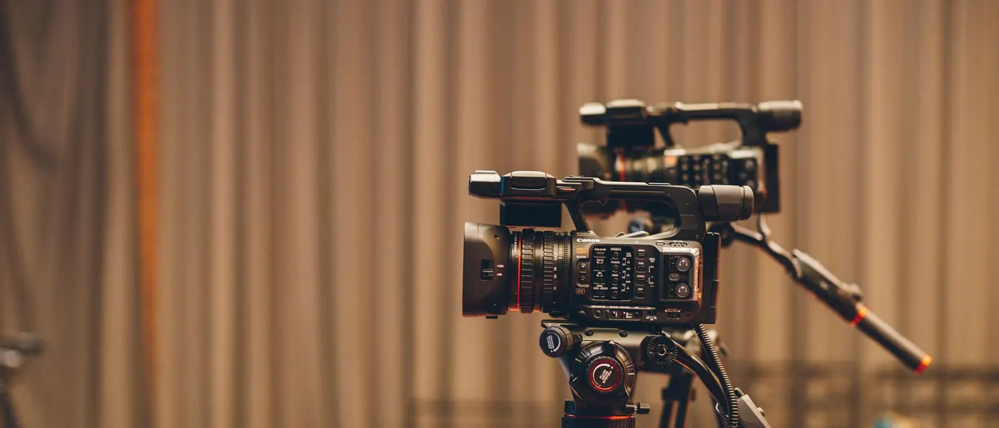 A cinema camera on a tripod on a film set