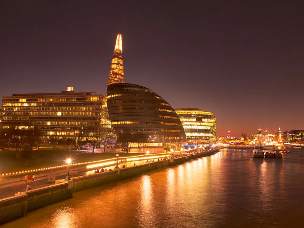 The River Thames in London at night with City Hall and the Shard lit up